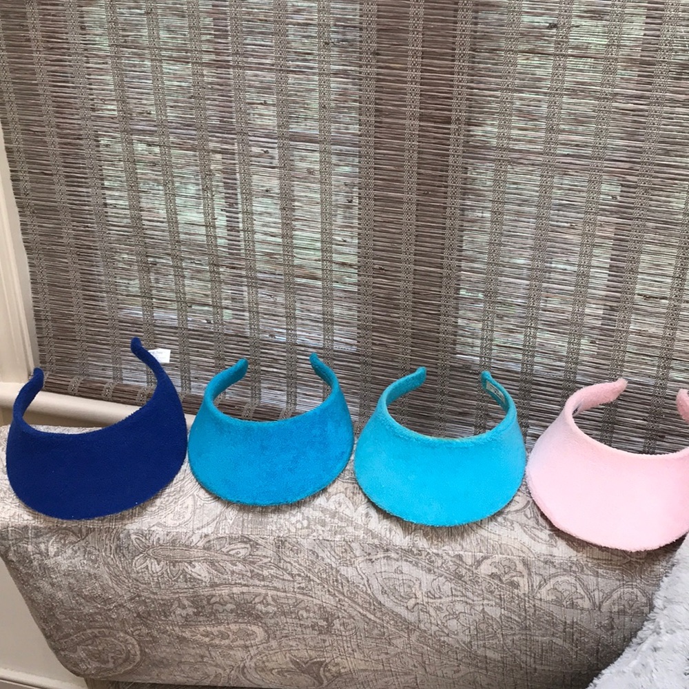 Four terrycloth visors in various shades